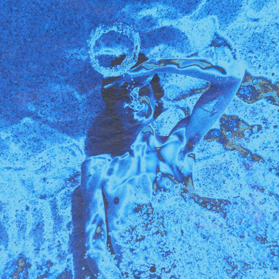The front album cover of Submerged featuring the late Keaton blowing rings underwater, everything has a blue filter.